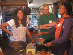 Participants in food preservation workshop make apple sauce. Note just-canned tomatoes in the foreground. Taken on Sunday, September 27th, 2009
